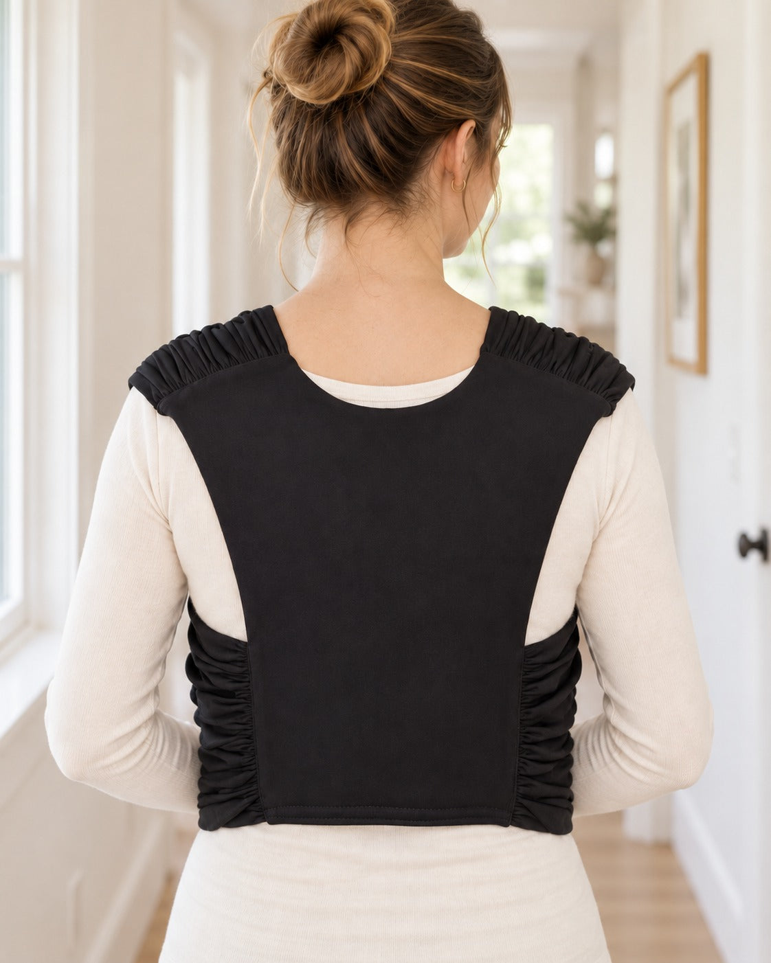 Back view of the Nuzzle Wrap showing the back panel and ruched shoulders